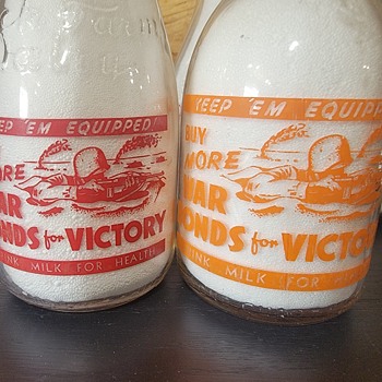 TWO WAR SLOGAN MILK BOTTLES..SOLDIER IN A FOXHOLE - Bottles