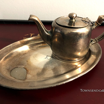 The T. EATON Co. Limited, Winnipeg Diamond "E" Saucer and Tea Pot circa. 1905 - Silver