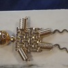 I could use help identifying gold tone humanoid brooch/pin and signature any information is appreciated 