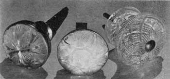 Cut Glass and Cast Compared: The two with cut-glass faces are mounted in brass bases. One retains the reflecting mirror behind the glass so that it appears to be of opalescent glass. At the right a cast-glass knob of intricate geometric pattern that seems to be also of lacy Sandwich in its design.